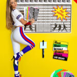 Brunette model showcasing an all-white football uniform in front of fantasy football draft board with top NFL players.